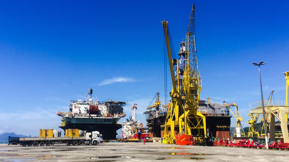 Offshore vessels and heavy lift cranes alongside a quayside